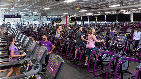 Planet Fitness members working out in a clean, spacious facility